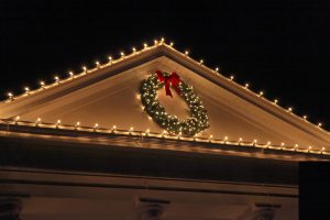 Christmas lights and wreath on home exterior