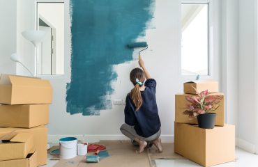 Woman Painting A Wall. Concept for Benefits Of Home Remodeling