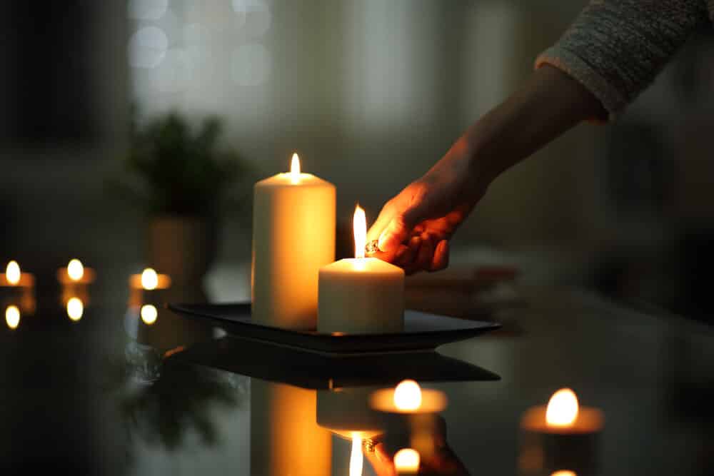 Close Up Of Woman Hand Lighting Candle In The Night, Power Outage, Does Not Own A Generator