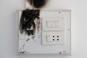 Outlet that is warped, burned and damaged from a power surge