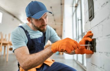 Technician performing electrical maintenance