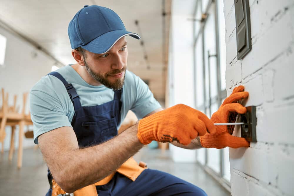 Technician performing electrical maintenance