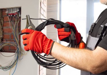 Electrician Wiring An Electrical Panel