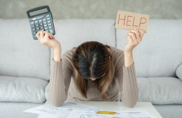 Stressed woman with large utility bills from energy vampires