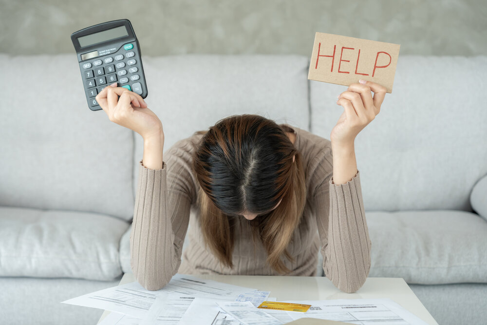 Stressed woman with large utility bills from energy vampires