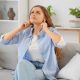 Young woman suffering from buzzing sound coming from electrical panel
