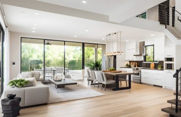 Stylish spacious kitchen and living room with refrigerator and w